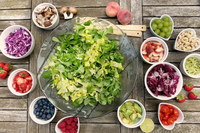A nutritious bowl of salad filled with an assortment of fresh fruits and vegetables, promoting a longer, healthier life.
