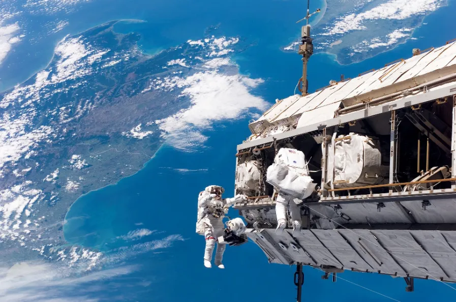 Astronauts conduct maintenance and experiments on the space station, their Home in the Sky.