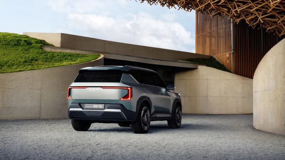 A rear view of the new Kia EV5 electric SUV, showing its sleek design and sporty tail lights.