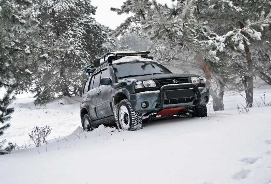 SUV driving through snowy terrain, ensuring Safety Security on Wheels.