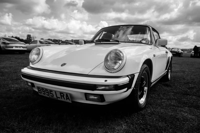 A classic car in a black and white photo, displaying its timeless allure and grace.