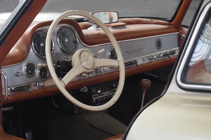 Classic car interior with steering wheel.