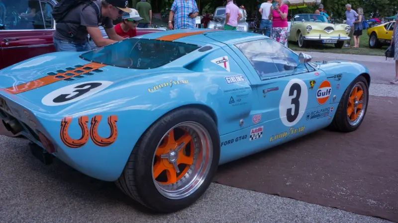 Blue and orange race car with number 3 on it.
