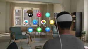 A man enjoying music in a living room filled with app icons on the wall.