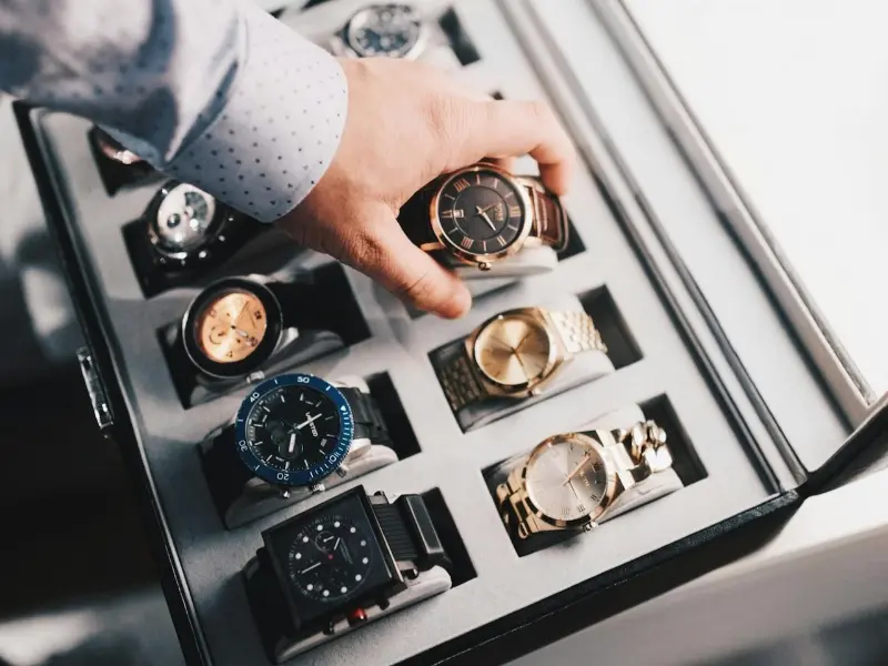 Hand selecting from a collection of the best luxury sport watches.